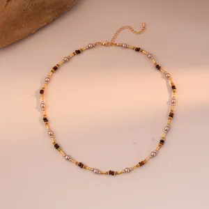 Close-up of tiger eye bead necklace with gold lobster clasp and extension chain
