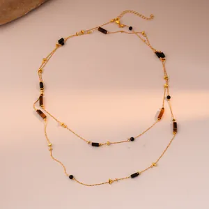 Close-up of double-layered gold tiger eye beaded necklace with lobster clasp detail