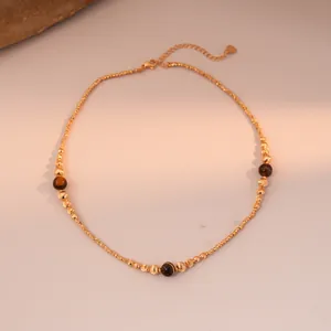 Detailed shot of golden tiger eye stone beaded necklace with elegant heart charm pendant