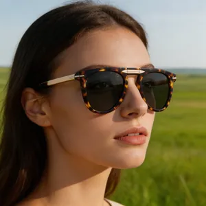 Close-up of tortoise shell sunglasses with gold metal temples on a female model