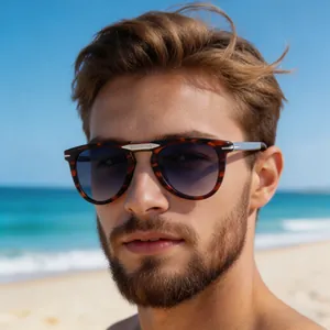 Close-up of tortoise shell sunglasses with silver metal details on a sunny beach
