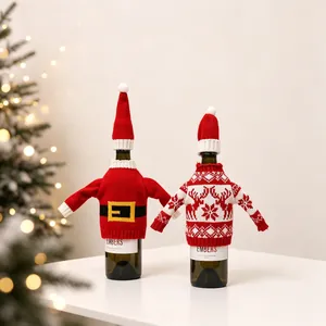 Detailed close-up of knitted Santa and reindeer Christmas wine bottle covers with mini hats