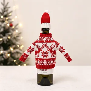 Close-up of red Christmas wine bottle cover with knitted reindeer and snowflake patterns