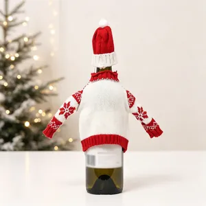Detailed view of red and white knit wine bottle covers with Nordic snowflake patterns