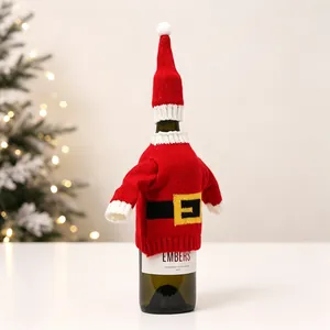Detail of Christmas Santa wine bottle cover with red knit sweater and hat on bottle