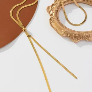 Minimalist adjustable gold snake chain necklace with lariat style slider on white background