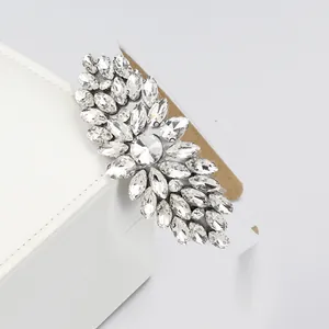 Baroque crystal headband featuring shiny rhinestone leaves on a white leather stand