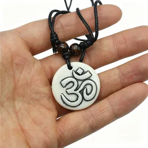 Sacred Hindu Om resin pendant necklace with white bone-like texture and black cord