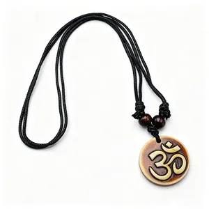 Macro view of Hindu Om symbol resin pendant with vintage bone-like texture and beads