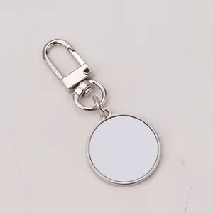 Macro detail of silver round sublimation keychain blank with lobster clasp and metal tray