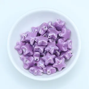 Macro shot of purple star-shaped ceramic beads with glazed finish for DIY jewelry