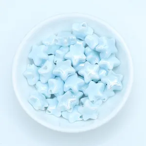 Macro detail of light blue pearlescent star ceramic beads for DIY jewelry making