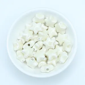 Close-up of creamy white star-shaped ceramic beads for DIY jewelry making
