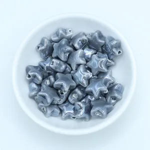 Macro detail of star-shaped ceramic beads with grey marble texture for jewelry DIY