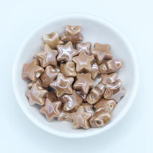 Macro shot of milk tea colored star ceramic beads with glossy glaze for DIY jewelry