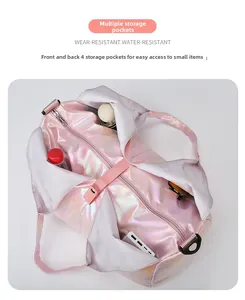 Detail view of pink holographic fitness bag showing four storage pockets and water resistance