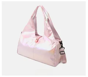 Close-up of pink holographic travel bag with adjustable strap and pearlescent finish