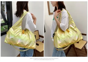 Detail view of holographic yellow fitness bag with adjustable straps and glossy finish