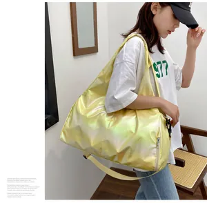 Detail view of yellow holographic travel bag with laser texture and shoulder strap