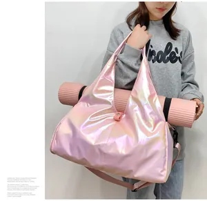 Detail of pink laser yoga bag featuring a dedicated strap for securing a yoga mat