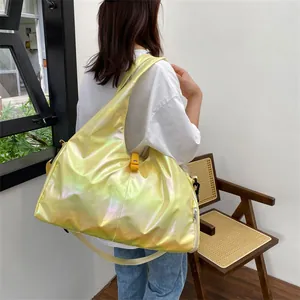 Modern holographic yellow travel bag with metallic luster worn by model in a minimal room