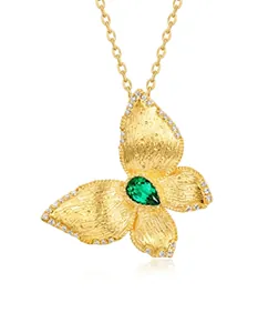 Detailed close-up of a brushed gold butterfly pendant featuring a pear-cut green gemstone