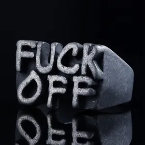 Detail of a punk style letter ring with embossed FUCK OFF text in vintage metal finish
