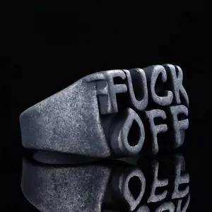 Macro detail of wide punk ring featuring embossed FUCK OFF text on antique silver metal