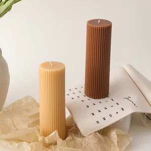 Textured cylinder soy wax candles set in beige and dark brown with vertical ribbing