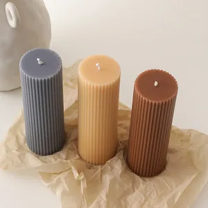 Top view of Roman column soy wax candles in three Morandi colors on kraft paper