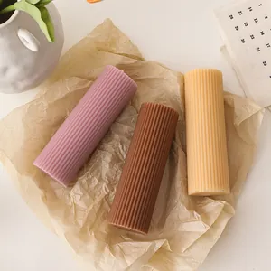 Vertical ribbed cylinder soy wax candles in pink, yellow and brown for home decor