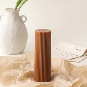 Detail shot of brown ribbed pillar candle showing fine texture on kraft paper