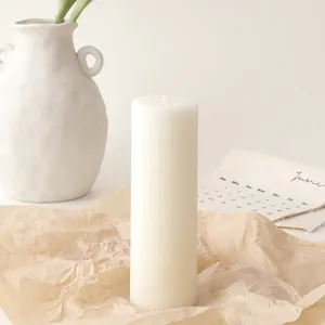 Macro detail of creamy white cylindrical soy candle with vertical striped texture pattern