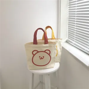 Minimalist canvas tote bags with cute cartoon bear prints in red and yellow colors