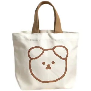 Detail of canvas lunch tote bag with brown bear print and matching woven handles