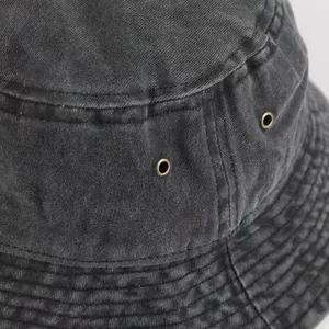 Detail of dark grey washed denim bucket hat with metal eyelets and reinforced stitching