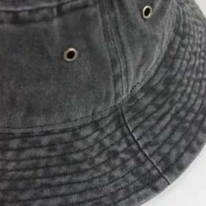 Close-up of vintage washed denim bucket hat showing metal eyelets and fine stitching