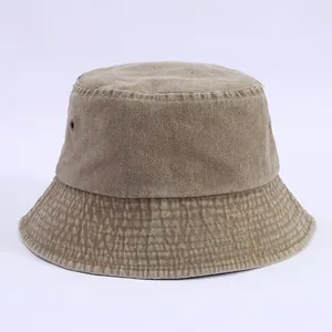 Detail view of khaki washed cotton bucket hat with tight stitching and metal air vents