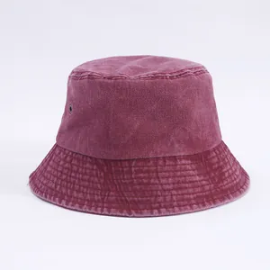Detail of burgundy washed denim bucket hat with metal eyelets and stitched brim