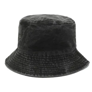 Detail view of washed black denim bucket hat with metal eyelets and reinforced stitching