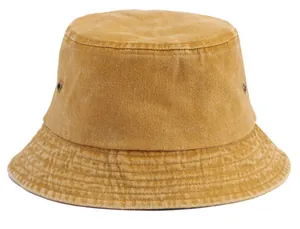 Detailed close-up of mustard yellow denim bucket hat with metal eyelets and stitching