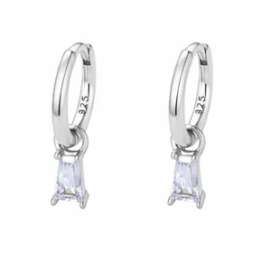 Macro detail of S925 sterling silver stamp and baguette-cut zircon on silver hoop earring