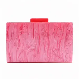 Vue détaillée de la pochette de soirée en acrylique avec texture marbre rose et fermoir
