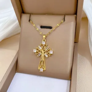 Macro view of gold crucifix necklace with micro-paved zircons in a jewelry box