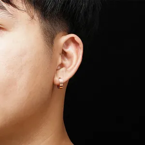 Rose gold titanium steel hoop earring worn on ear, unisex fashion jewelry accessories