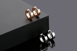 Detail view of minimalist stainless steel hoop earrings in rose gold and silver finish