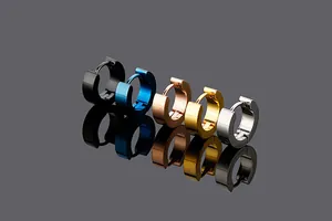 Detail view of five multi-colored titanium steel hoop earrings on reflective surface