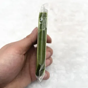 Close-up of 1cm dark green velvet ribbon roll packed in a clear plastic bag for DIY use