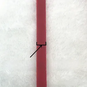 Detail of 10mm wide dark red velvet ribbon with a smooth shiny texture for gift DIY
