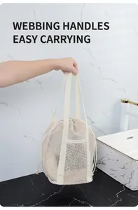 Detail of mesh beach bag with sturdy woven handles and convenient drawstring closure